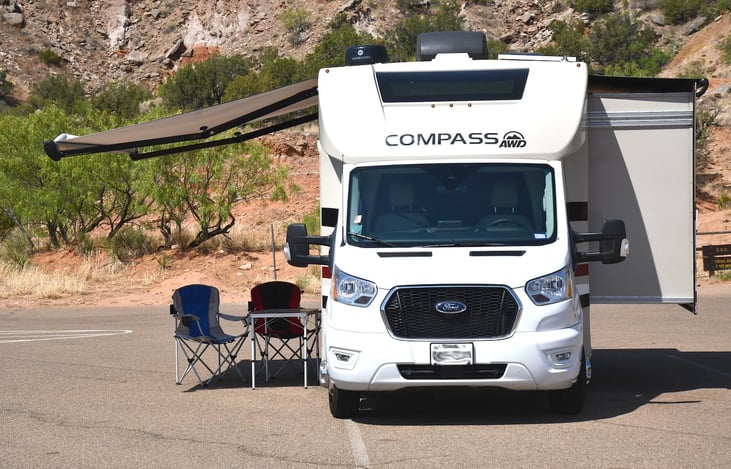 With slide & awning out. Includes table & chairs (up to 4 chairs) & gas grill.