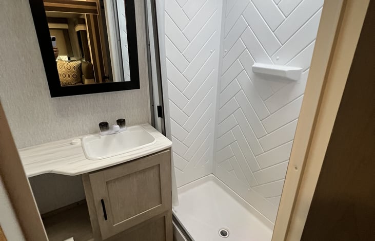 Full bathroom with sink and shower.