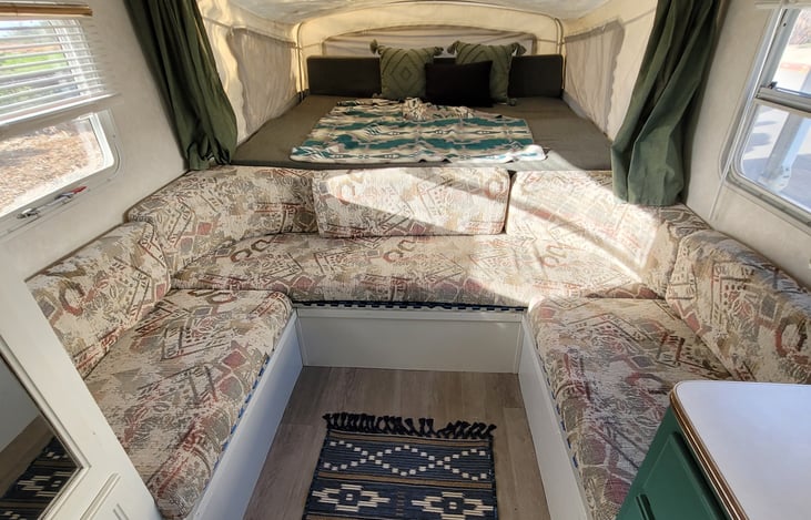 Front Pop out tent (Queen Mattress), climb over U shape Dinette with the option to sleep two more kids or 1 teen across the back bench. Small Black collapsible table provided.