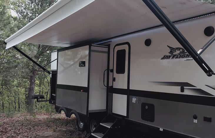 The front of.
 The camper with the awning.