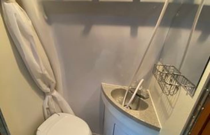 Enclosed wet bathroom with shower and sink