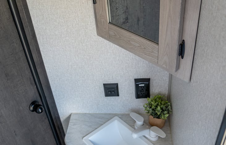 spacious vanity features storage below and above for all of your personal items.