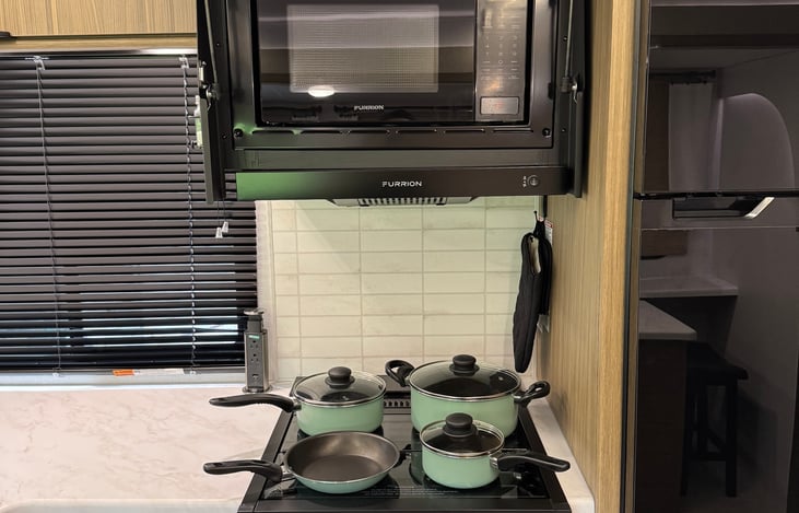 Kitchen includes ample counter tops, oven and hidden microwave.  Pots included with rental.