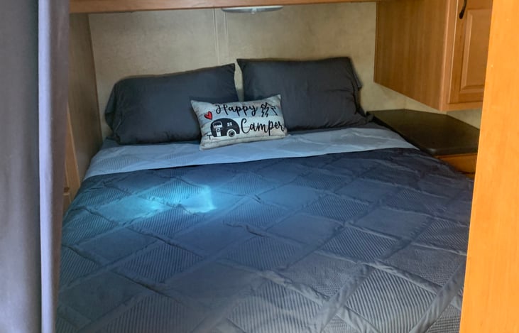 Queen size bed in back bedroom