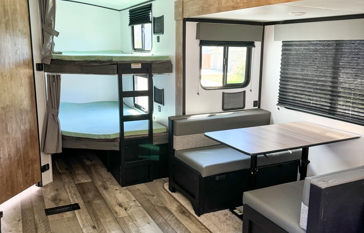 Standing at the kitchen and looking at the bunks. Two full size bunks.