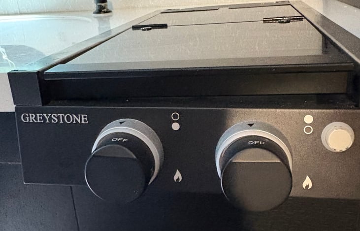 Two burner electric stove, pans, and cooking utensils provided.