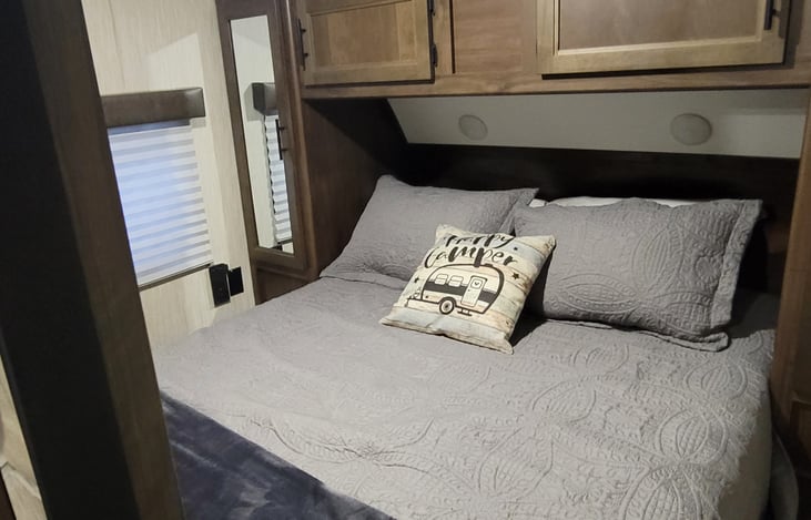 Very comfortable upgraded queen mattress. Sliding doors close for privacy. Two hanging clothes closets, two above the bed storage areas, and the bed lifts up for additional storage.
