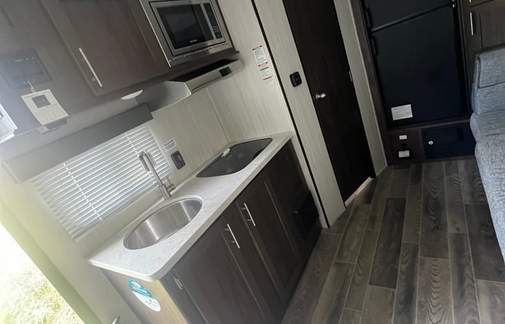 Cabinet storage, microwave and full sink.