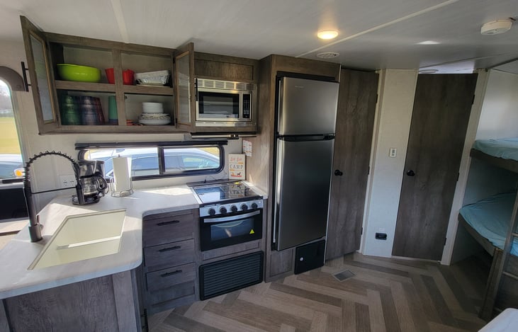 Kitchen | 3 burner stove and oven | 10.7 CU FT 12 volt Refrigerator | Microwave