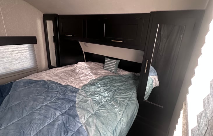 Queen size plush mattress. 
Bed room has access/ curtains to both sides of bed.