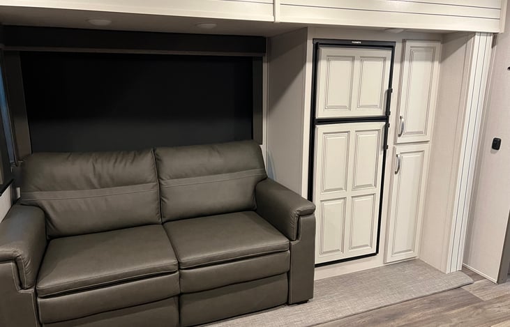 Couch folds out into bed, fridge and pantry on the right