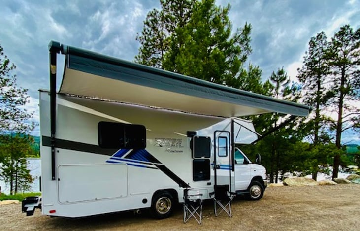 Well-lit outdoor entertainment area complete with TV and Bluetooth soundbar