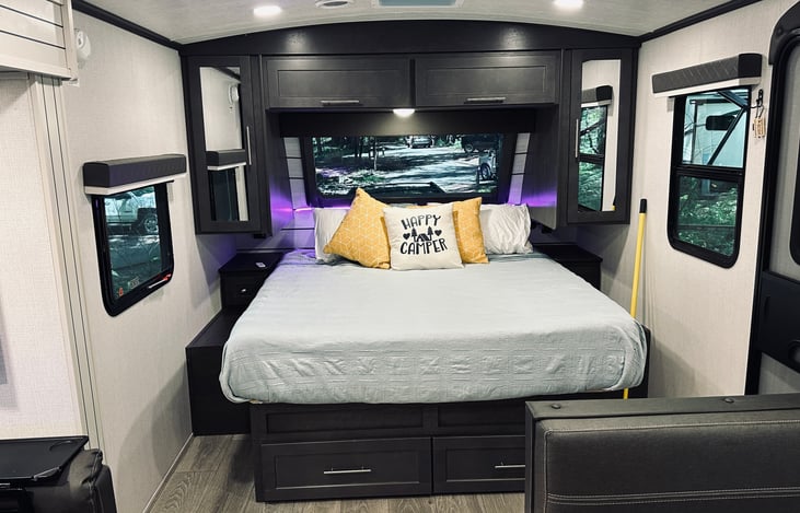Olympic Queen-sized after market mattress. Added LED lighting. Large front window (pull-down shades throughout).
