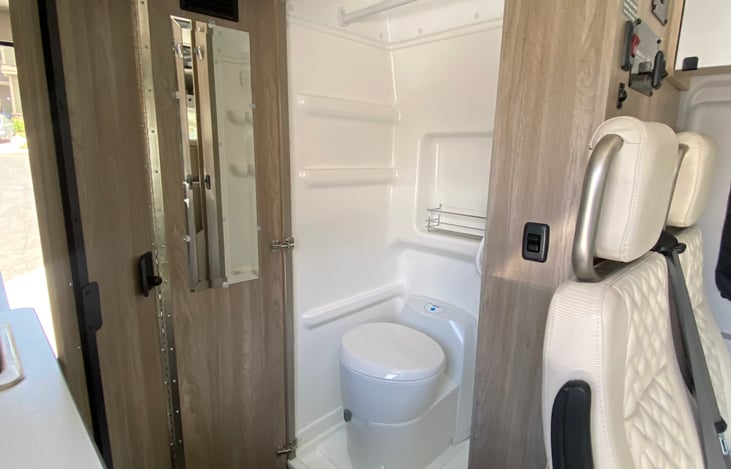 Cassette toilet and shower with generous sized mirror.  You can keep that door open at night for privacy as well