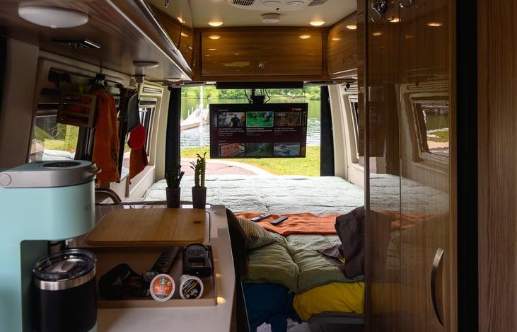 TV with electric mount that lowers the screen for watching in bed or while working in the kitchen.