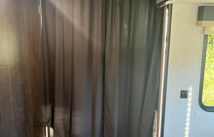 The bunk beds have curtains that slide across for privacy