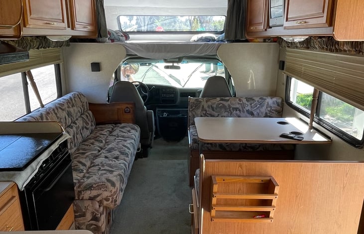 Dinette table, couch, full kitchen, overhead cab for extra sleeping/storage. The dinette and couch fold into more sleeping areas.