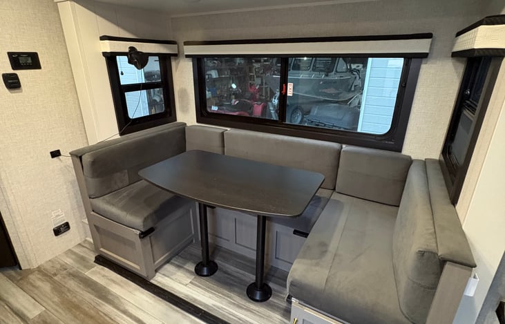 Spacious U-shaped dinette with convertible bed.