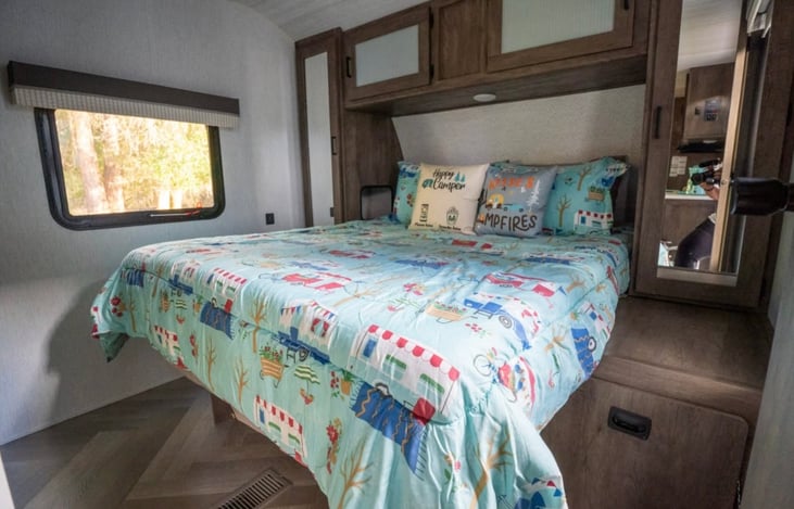 Master queen bed, 2 closets, storage baskets and cabinets above. TV in room