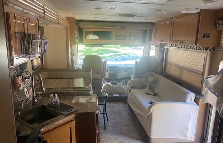 Couch and dinette both turn into beds if need be.  Driver and passenger seats rotate towards living area, and extra table fits between.