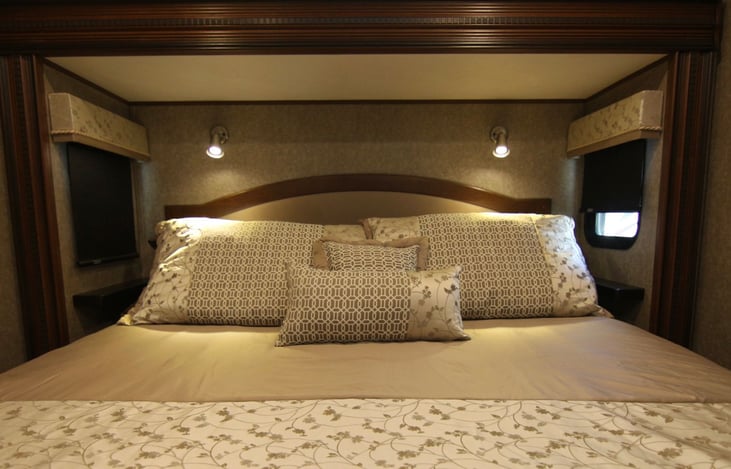 Master king bed with safe beneath in under bed storage.