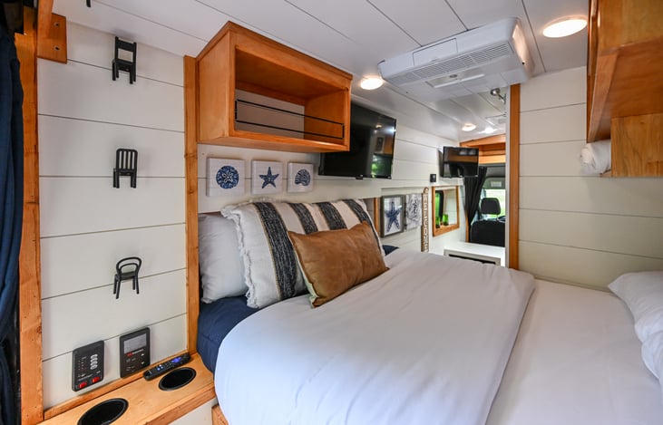 Relax in a cozy, comfortable full size bed with fresh linens, overbed storage for your essentials, soft towels included, and convenient wall hooks to keep your gear organized and accessible.