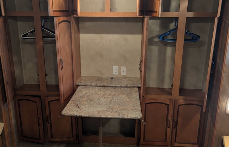 Back bedroom storage on both sides includes closets, cabinets and fold out attached table.