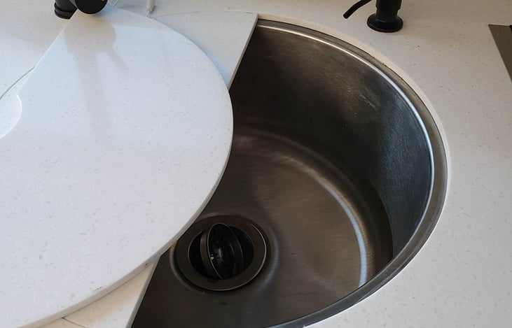The sink has a cover on it for that added counter space. Dish soap is included on the soap pump.
