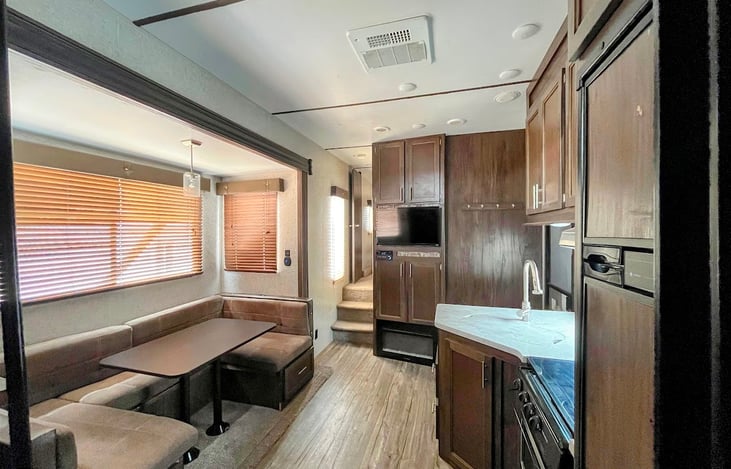 Fully furnished kitchen with dinette that turns into a bed. Working Tv, dvd player, and fireplace. USB plug in and outlet by table.