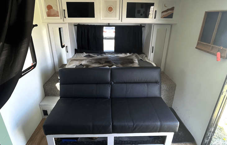 Queen bed folded away giving you a couch for more seating.