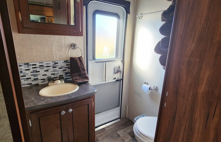 Bathroom complete with sink, toilet, tub, shower, and exit door.