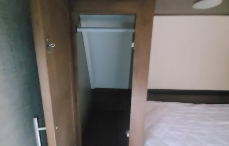 bedside closets have bars for hanging and each side has USB charging ports.