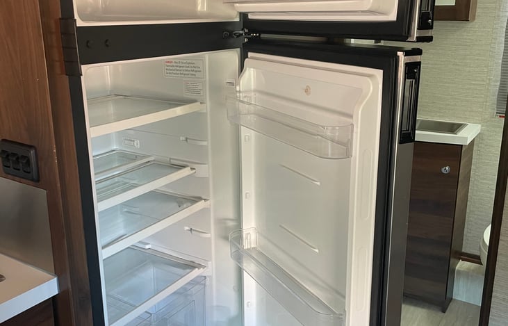 Fridge and freezer with doors open.