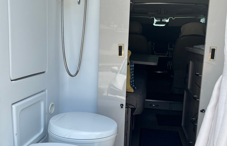 Cassette toilet, shower nozzle and sink folded up