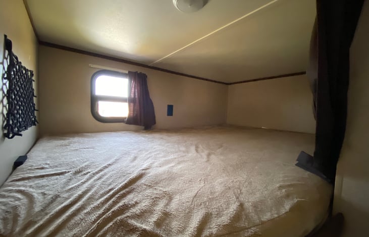 Top bunk, can sleep one adult comfortably or two children.