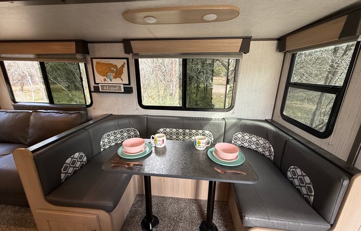 Dinette easily converts into an additional sleeping area, with bedding conveniently stored underneath.