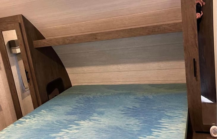 Separate master bedroom with a queen bed, TV, fan, double wardrobe closets and closed off door for extra privacy.