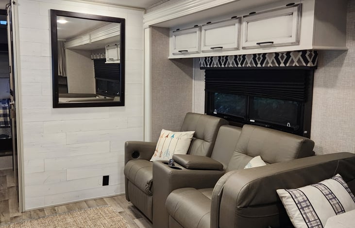 Theater-seating across from fireplace + HDTV