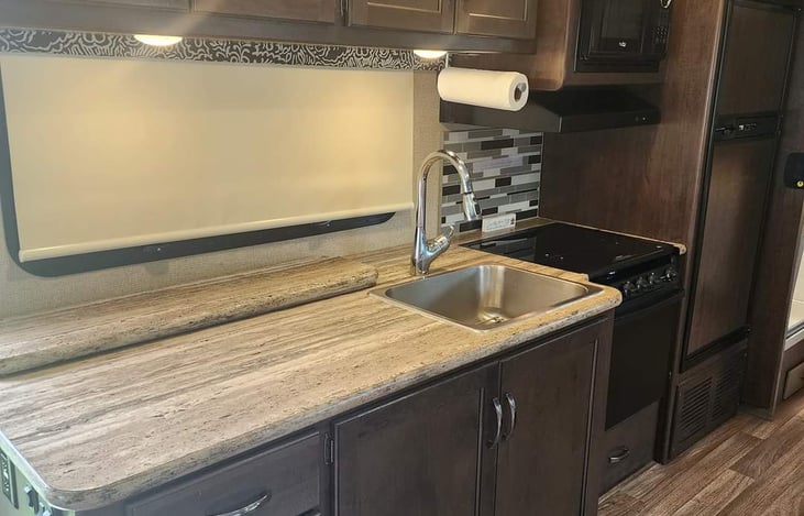 Fully stocked with utensils, plates, bowls, silverware, cookware (pots and pans), cooking utensils, toaster,  microwave, fridge/freezer, and coffee maker. PLENTY of storage for all of your groceries