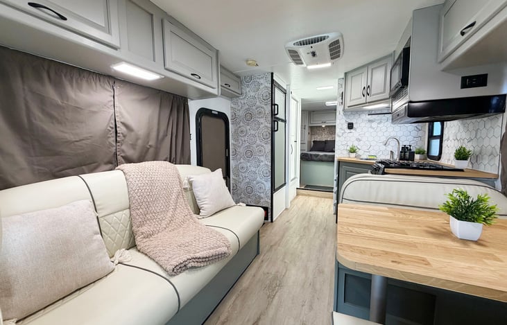 Fully equipped RV interior with kitchen, dining area & comfortable seating – Las Vegas road trip ready