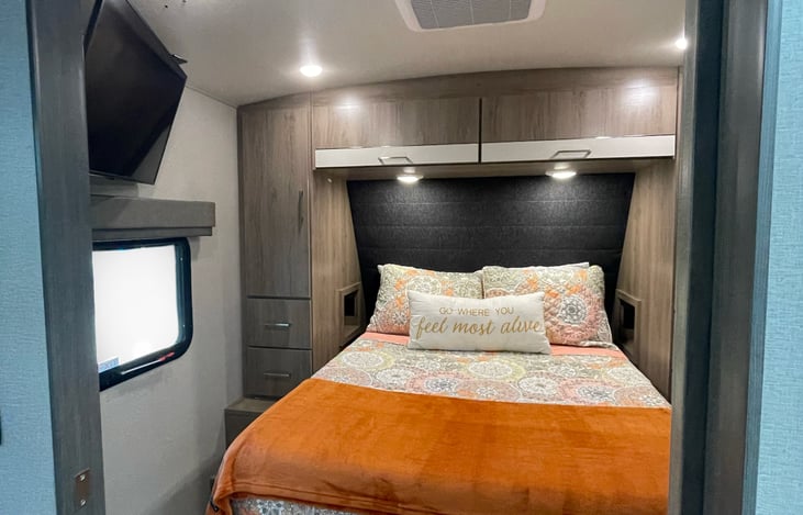 The Master bedroom, 1st Smart TV, lots of storage room under and alongside the bed, 1st door, Fire escape window.