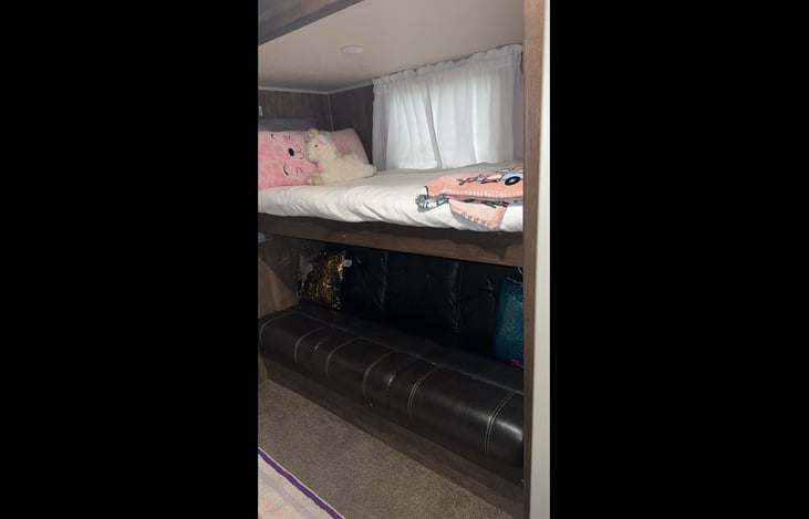 Upper bunk- sleeps 1
 Flip down couch that converts to a bed, can sleep 2 children comfortably.  Between a  Full and Twin size.