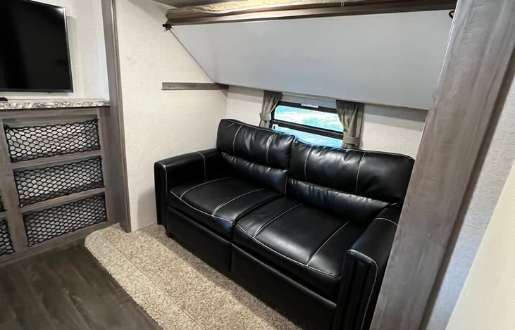 Tri-fold sofa bed and bunk bed above.