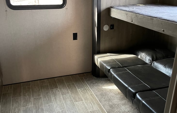 Sofa bed in the bunkhouse, with the top bed put down.