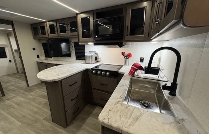 Kitchen features upscale finishes, cozy space, endless adventures.