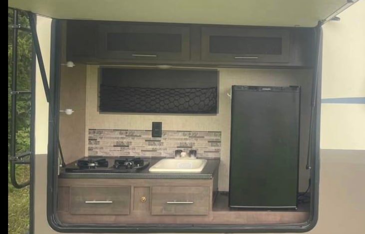 large outdoor kitchen with mini fridge for keeping your beverages nice and cold