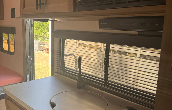 Full kitchenette. Sink w/ Hot a Cold Water, fridge, microwave, and stove top. Plenty of cabinet storage.