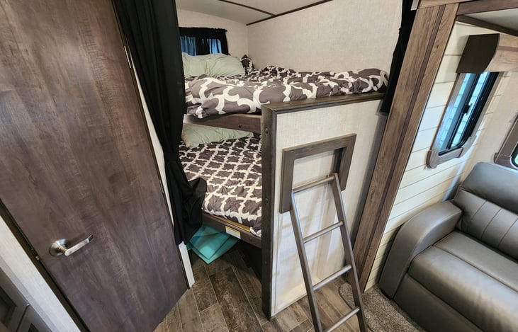 Huge Twin XL bunks with storage underneath and privacy curtain.