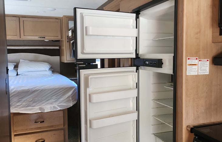Spacious fridge and freezer. Operates automatically switching from Propane to mains electric when plugged in on site and back to gas when off site