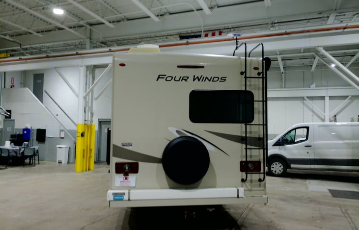 Back of RV. Spare tire attached and stable ladder to the roof. Starlite for WIFI can be mounted on the roof.